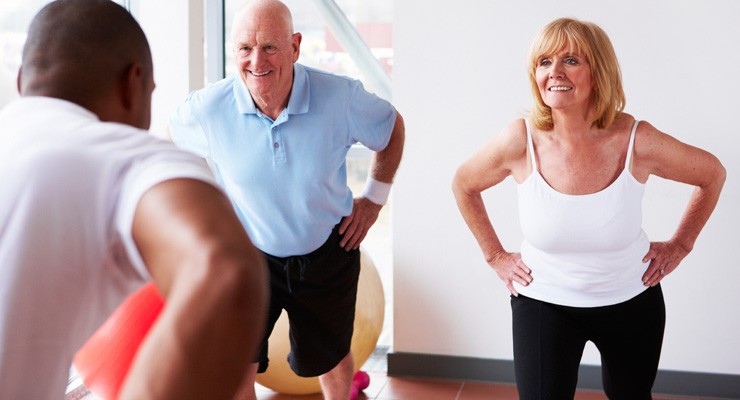 man and women exercising in gym