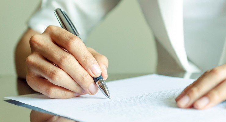 image of hand writing on piece of paper